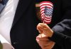 Child's hand holding an American flag