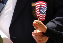 Child's hand holding an American flag