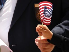 Child's hand holding an American flag