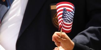 Child's hand holding an American flag