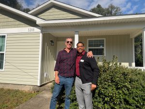 new home owner standing outside is home 