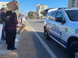 Police stop in front of protesters to give them water and safety tips