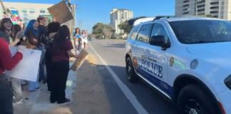 Police stop in front of protesters to give them water and safety tips