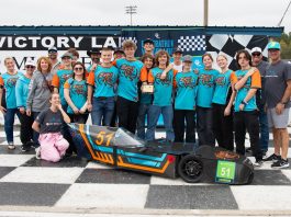 Students standing in a group in front of their speed vehicle