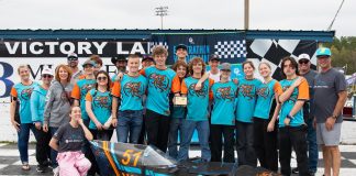 Students standing in a group in front of their speed vehicle