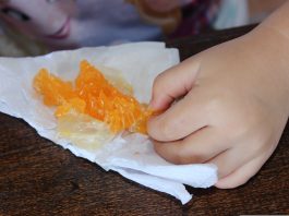 A child eating an orange