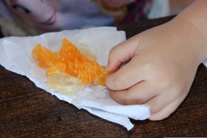 A child eating an orange