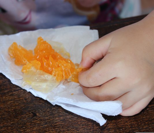 A child eating an orange