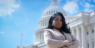 Tamika Lyles standing in front of the White House with her arms crossed