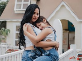 Mother and child embracing.