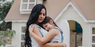 Mother and child embracing.