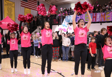 Cheerleaders cheering at a school pep rally