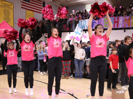 Cheerleaders cheering at a school pep rally