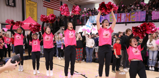 Cheerleaders cheering at a school pep rally