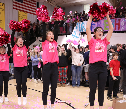 Cheerleaders cheering at a school pep rally